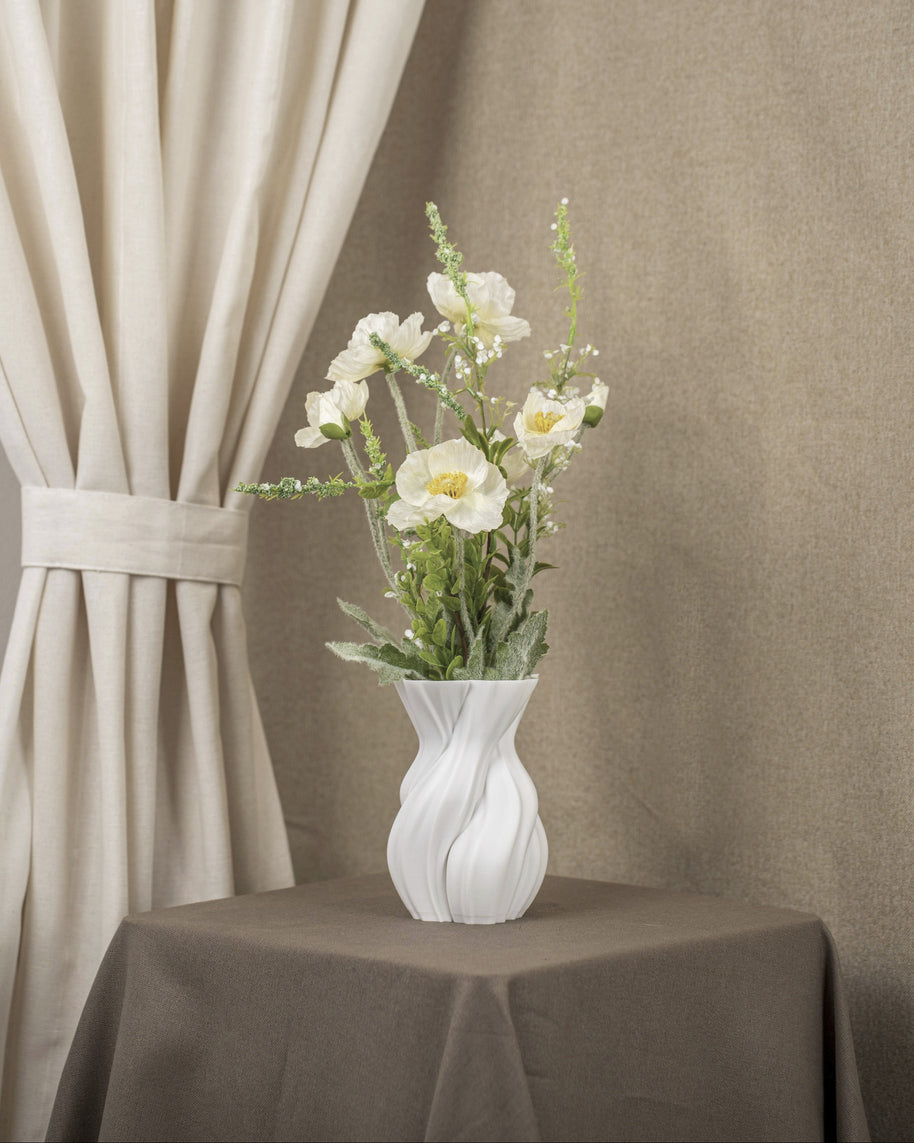 Vintervad Design Anna white sculptural vase with organic tree-inspired lines, filled with white artificial flowers.