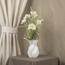 Vintervad Design Anna white sculptural vase with organic tree-inspired lines, filled with white artificial flowers.