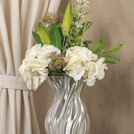 Vintervad Design Anna white sculptural vase with organic tree-inspired lines, filled with a bouquet of white flowers.