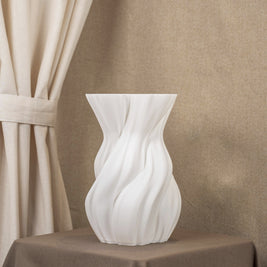 Vintervad Design white sculptural vase with organic twisted tree-inspired lines made from sustainable grain materials.
