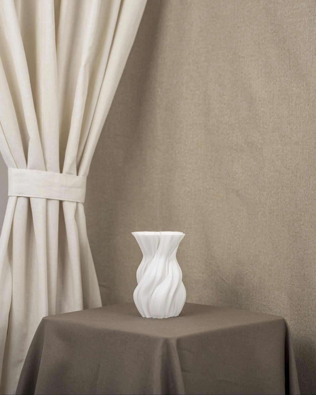 Vintervad Design white sculptural vase with organic twisted tree-inspired lines made from sustainable grain materials.