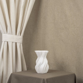 Vintervad Design white sculptural vase with organic twisted tree-inspired lines made from sustainable grain materials.